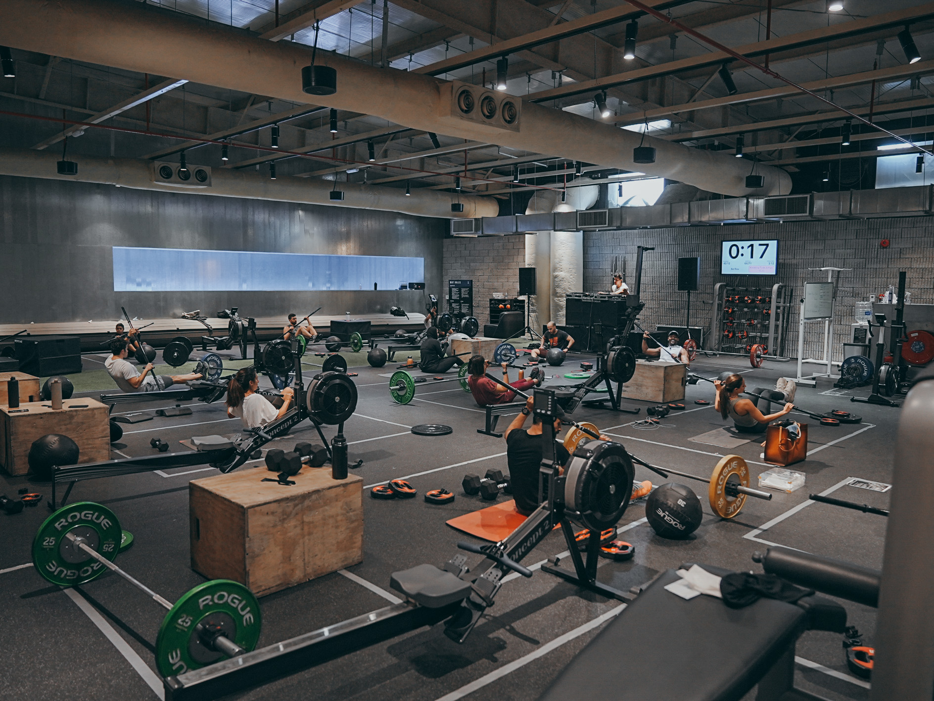 Full gym class with multiple athletes training simultaneously in spacious facility