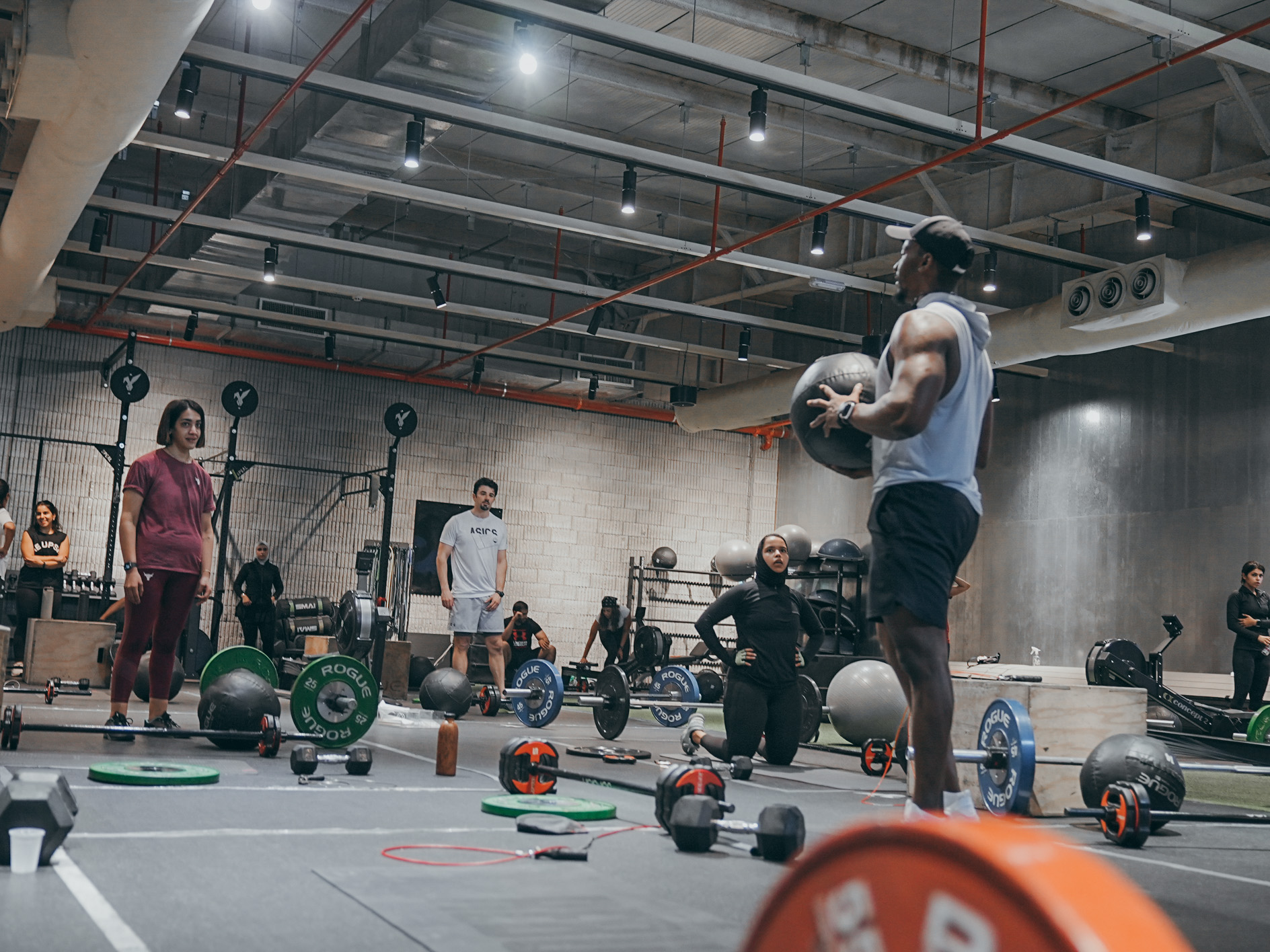 Functional fitness class with athletes performing varied movements