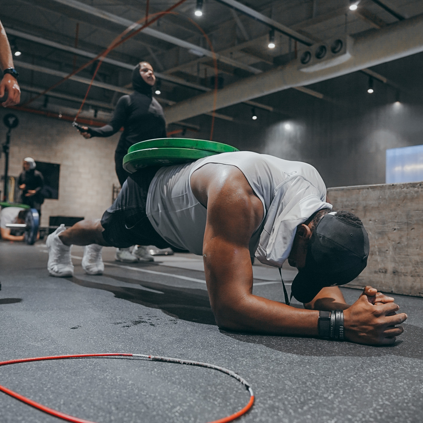 Athletes performing plank exercises with resistance bands in group setting